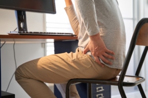 male businessman who suffers hip pain from working from home